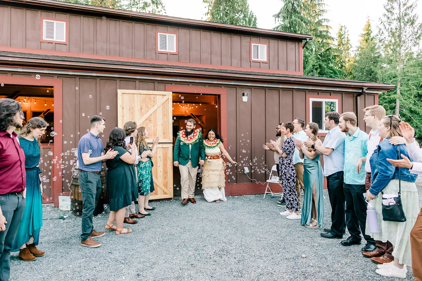Newlyweds walking through a bubble send-off in traditional and formal wedding attire